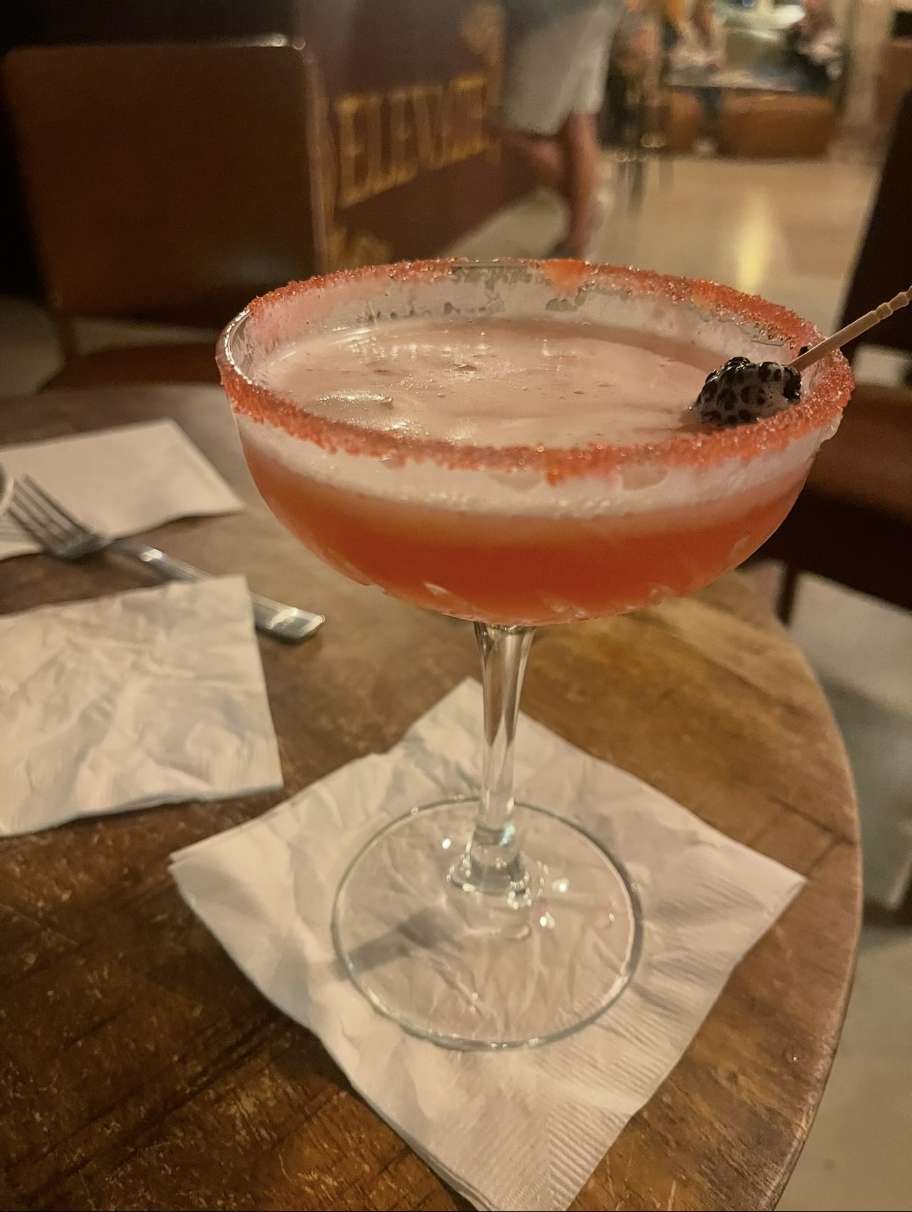 Handcrafted cocktail with sugared rim and blackberry garnish